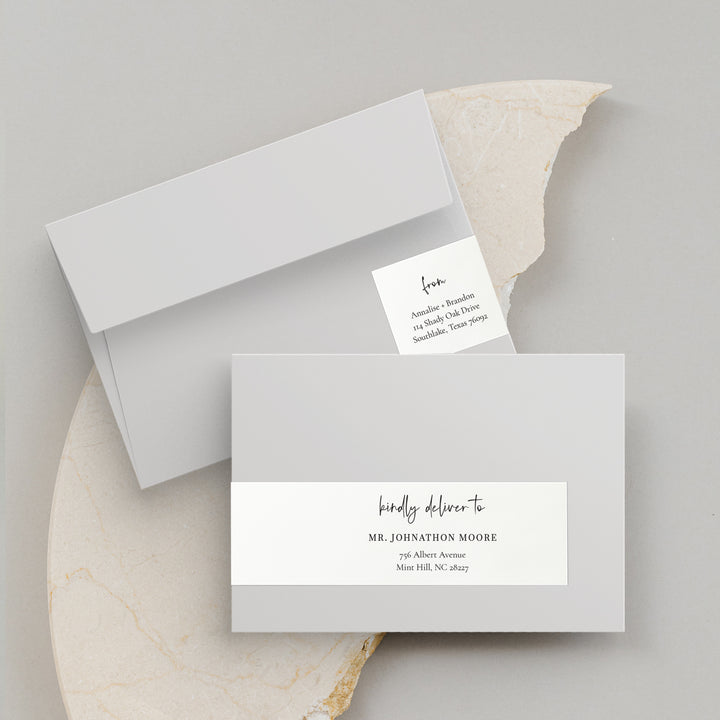 Labels on grey envelopes on a neutral background. Modern Initials Collection